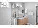 Bathroom featuring a double vanity, large mirror, and a walk-in shower at 2263 Wyndham Palms Way, Kissimmee, FL 34747