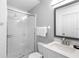 Bathroom featuring a walk-in shower with white tile and a modern vanity at 2263 Wyndham Palms Way, Kissimmee, FL 34747