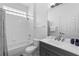 Well-lit bathroom with a shower and tub combination, vanity, and neutral tile at 2263 Wyndham Palms Way, Kissimmee, FL 34747