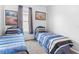 Bedroom featuring twin beds, neutral walls, and window at 2263 Wyndham Palms Way, Kissimmee, FL 34747