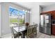 Bright dining area featuring a large window overlooking the backyard and pool area at 2263 Wyndham Palms Way, Kissimmee, FL 34747