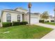 Well-kept home with a lush green lawn, mature palm tree, and neat landscaping enhancing curb appeal at 2263 Wyndham Palms Way, Kissimmee, FL 34747