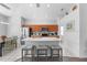 Modern kitchen with stainless appliances, center island with seating and pendant lighting at 2263 Wyndham Palms Way, Kissimmee, FL 34747