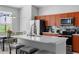 Modern kitchen boasts stainless steel appliances and sleek countertops at 2263 Wyndham Palms Way, Kissimmee, FL 34747