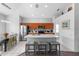 Modern kitchen with stainless steel appliances, a breakfast bar, and a view into the dining area at 2263 Wyndham Palms Way, Kissimmee, FL 34747