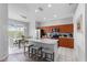 Modern kitchen with an island, stainless steel appliances, and a breakfast nook with natural light at 2263 Wyndham Palms Way, Kissimmee, FL 34747