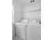 Convenient laundry room featuring a washer, dryer, and storage shelves at 2263 Wyndham Palms Way, Kissimmee, FL 34747