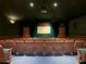 This is a spacious home theater featuring comfortable seating and a large screen for an immersive viewing experience at 2263 Wyndham Palms Way, Kissimmee, FL 34747