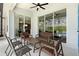 Covered patio features comfortable seating and views of the pool and backyard at 2263 Wyndham Palms Way, Kissimmee, FL 34747
