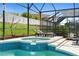Inviting screened-in pool and spa area, perfect for relaxation and outdoor living at 2263 Wyndham Palms Way, Kissimmee, FL 34747