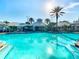 An inviting outdoor pool with lounge chairs and umbrellas, perfect for relaxation and recreation at 2263 Wyndham Palms Way, Kissimmee, FL 34747