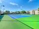 A vibrant tennis court complex with well-maintained green and blue courts for recreational play and community engagement at 2263 Wyndham Palms Way, Kissimmee, FL 34747