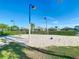 Sandy volleyball court with a net and lighting, perfect for outdoor games and recreation under the blue sky at 2263 Wyndham Palms Way, Kissimmee, FL 34747