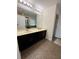 Bathroom with double vanity and large mirror with access to the shower at 2656 River Landing Dr, Sanford, FL 32771