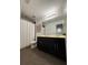 Well-lit bathroom with a double vanity, framed mirror, and neutral decor at 2656 River Landing Dr, Sanford, FL 32771