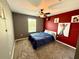 Cozy bedroom features a ceiling fan, plush carpeting, and a fun accent wall at 2656 River Landing Dr, Sanford, FL 32771