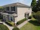 Side view of a two-story townhome showcasing manicured landscaping, a brick walkway and architectural details at 2656 River Landing Dr, Sanford, FL 32771