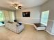 Comfortable living room featuring a ceiling fan, neutral tones, and sliding door access to the patio at 2656 River Landing Dr, Sanford, FL 32771
