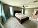 Spacious main bedroom with carpeting, large windows, and a ceiling fan at 2656 River Landing Dr, Sanford, FL 32771