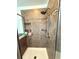 Updated shower featuring a mosaic tile accent, rain shower head, and built-in shelving at 2656 River Landing Dr, Sanford, FL 32771