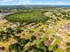 An aerial view highlights the property's convenient location within a green community near a forest and serene lake at 2726 La Alameda Ave, Kissimmee, FL 34746
