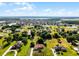 This aerial shows the home's location in a community with lakes and the nearby city skyline in the distance at 2726 La Alameda Ave, Kissimmee, FL 34746