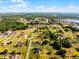 An aerial view of a residential community near a forest, lake, and local roads offers a peaceful and convenient lifestyle at 2726 La Alameda Ave, Kissimmee, FL 34746
