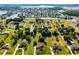Aerial view of neighborhood with a mix of houses, trees, and a lake, showcasing the serene community at 2726 La Alameda Ave, Kissimmee, FL 34746