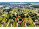 Aerial view showcasing a home with a red tile roof surrounded by lush greenery in a beautiful neighborhood at 2726 La Alameda Ave, Kissimmee, FL 34746