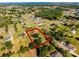 This aerial view shows the property boundaries in red, highlighting the property's generous lot surrounded by trees at 2726 La Alameda Ave, Kissimmee, FL 34746