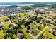 Neighborhood aerial showcasing the home's location with surrounding houses, greenery and lakes at 2726 La Alameda Ave, Kissimmee, FL 34746