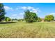 The home has a large backyard with mature trees and well-maintained grass at 2726 La Alameda Ave, Kissimmee, FL 34746