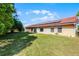 Spacious backyard with a well-maintained lawn, providing ample space for outdoor activities and relaxation at 2726 La Alameda Ave, Kissimmee, FL 34746