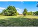 Expansive backyard features mature trees and a lush lawn, ideal for outdoor activities at 2726 La Alameda Ave, Kissimmee, FL 34746