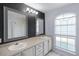 Elegant bathroom with double vanity, tiled countertop, and stylish lighting fixtures at 2726 La Alameda Ave, Kissimmee, FL 34746