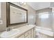 This bathroom features a double sink vanity, a large mirror, and a shower-tub combo at 2726 La Alameda Ave, Kissimmee, FL 34746