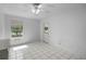 Bedroom featuring tile floors, a window, a ceiling fan, and access to the exterior of the home at 2726 La Alameda Ave, Kissimmee, FL 34746