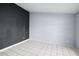 An empty bedroom is seen with muted walls and neutral tile flooring at 2726 La Alameda Ave, Kissimmee, FL 34746