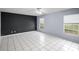 Bright bedroom with tiled floors, ceiling fan, and natural light streaming through the windows at 2726 La Alameda Ave, Kissimmee, FL 34746
