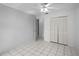 This bedroom has tile floors, a ceiling fan, and closet with louvered doors at 2726 La Alameda Ave, Kissimmee, FL 34746