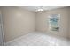 This bedroom features tile floors, a window, and a ceiling fan at 2726 La Alameda Ave, Kissimmee, FL 34746