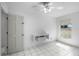 Bedroom with modern shelving, tile floors, a ceiling fan, and a large window at 2726 La Alameda Ave, Kissimmee, FL 34746