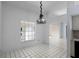 Dining area featuring tiled floors, arched doorway, and a hanging chandelier at 2726 La Alameda Ave, Kissimmee, FL 34746