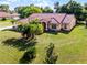 Beautiful property featuring a terracotta roof, lush green lawn, and mature landscaping for ultimate curb appeal at 2726 La Alameda Ave, Kissimmee, FL 34746
