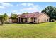 Lovely single-Gathering home with a well-kept lawn, complemented by mature trees and landscaped features at 2726 La Alameda Ave, Kissimmee, FL 34746