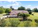 Attractive home with a red tile roof and lush green lawn, framed by beautiful landscaping and blue skies at 2726 La Alameda Ave, Kissimmee, FL 34746