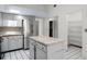 Bright kitchen with stainless steel refrigerator and kitchen island for extra storage and prep space at 2726 La Alameda Ave, Kissimmee, FL 34746