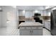 The kitchen features neutral countertops, island, white cabinets, and stainless steel microwave at 2726 La Alameda Ave, Kissimmee, FL 34746