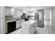 This kitchen showcases white cabinets, island, stainless steel appliances, and black tile floors at 2726 La Alameda Ave, Kissimmee, FL 34746