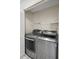 Laundry area with modern silver washer and dryer, complemented by white shelving at 2726 La Alameda Ave, Kissimmee, FL 34746